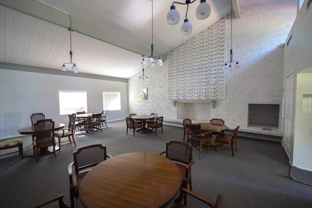 carpeted dining room featuring beamed ceiling, an outdoor fireplace, and high vaulted ceiling