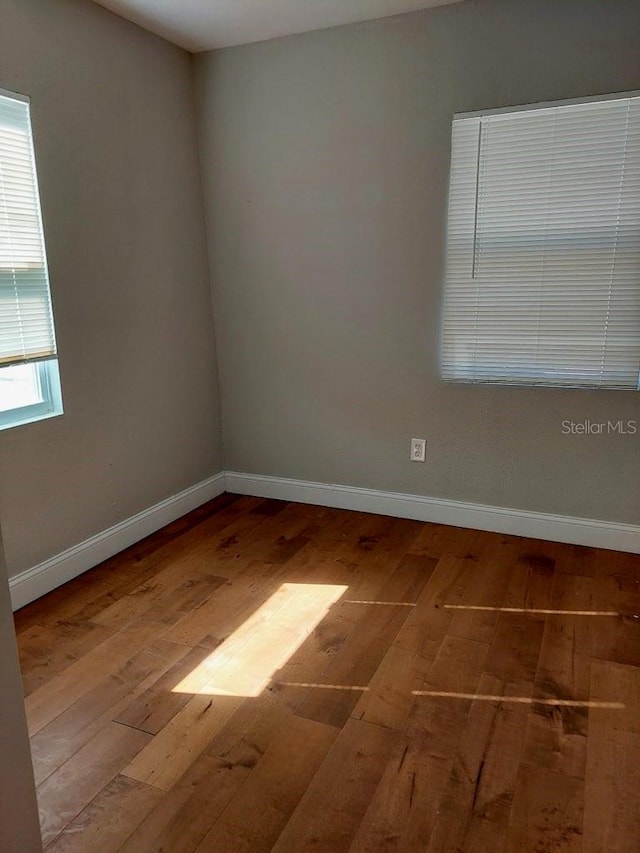 unfurnished room with wood-type flooring