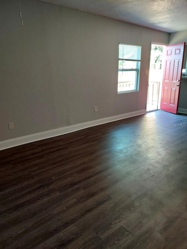 entrance foyer featuring dark hardwood / wood-style flooring and a textured ceiling