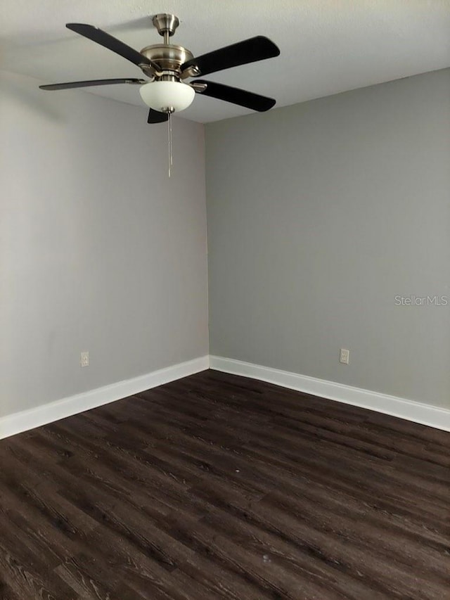 unfurnished room featuring dark hardwood / wood-style flooring and ceiling fan