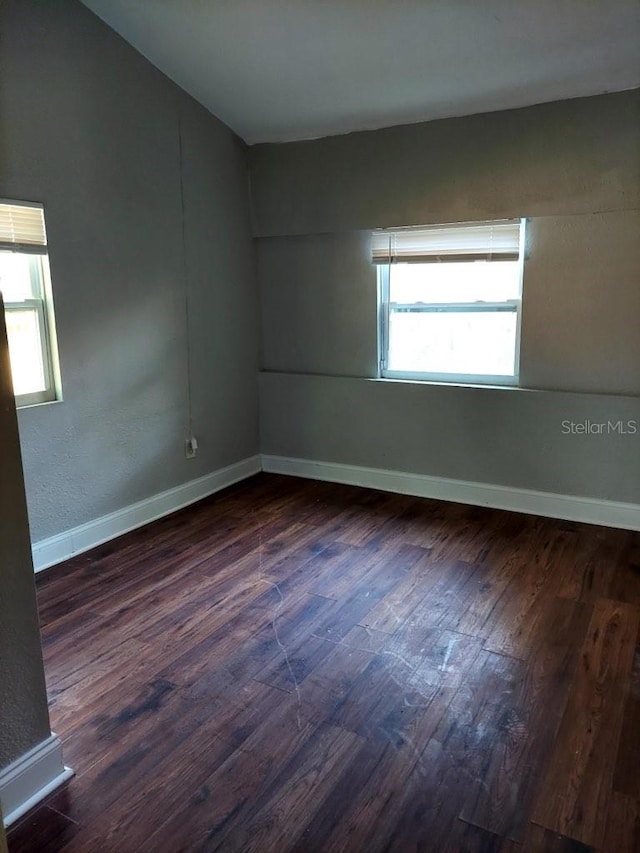 empty room featuring dark hardwood / wood-style flooring