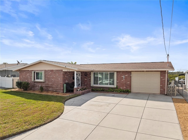 ranch-style home with a garage and a front yard