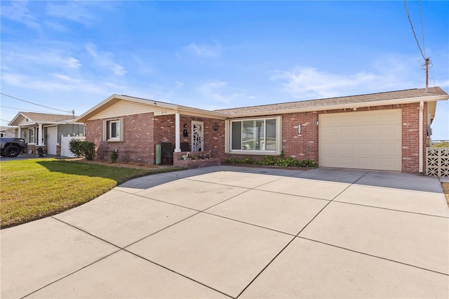 ranch-style home featuring a garage and a front lawn