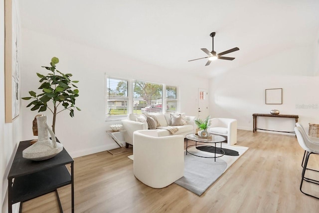 living room featuring ceiling fan, lofted ceiling, and light hardwood / wood-style floors