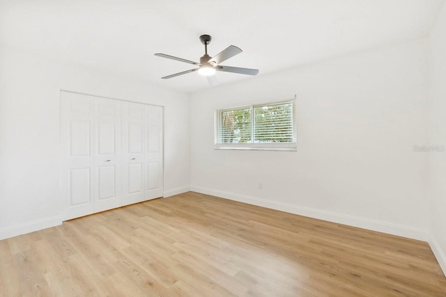 unfurnished bedroom featuring ceiling fan, a closet, and light hardwood / wood-style flooring