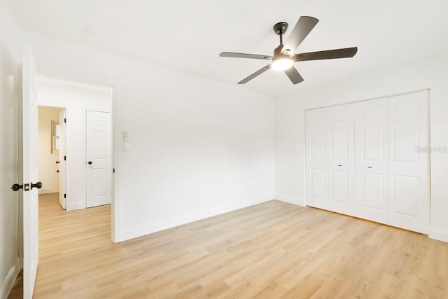 unfurnished bedroom featuring light hardwood / wood-style flooring, a closet, and ceiling fan