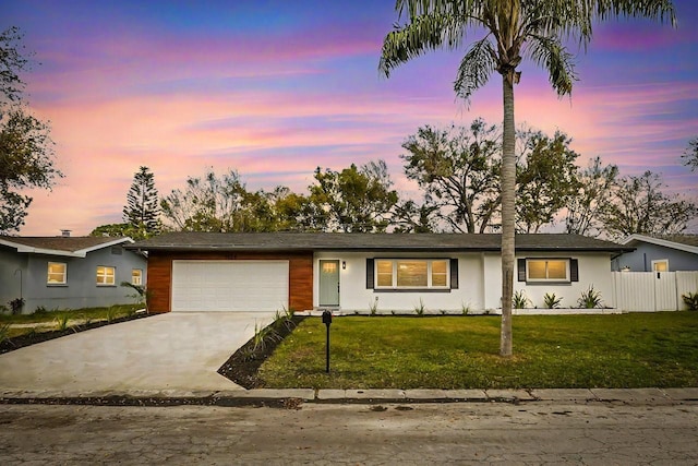 single story home with a yard and a garage