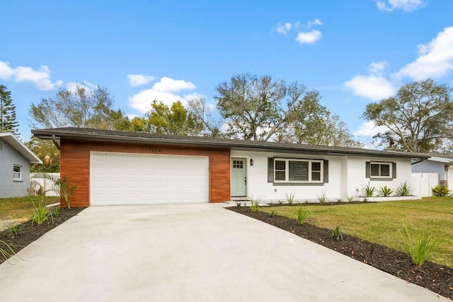 single story home with a garage and a front yard