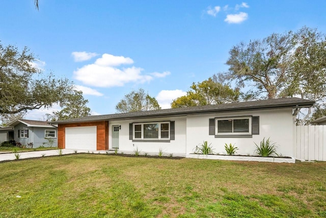 ranch-style home with a garage and a front lawn