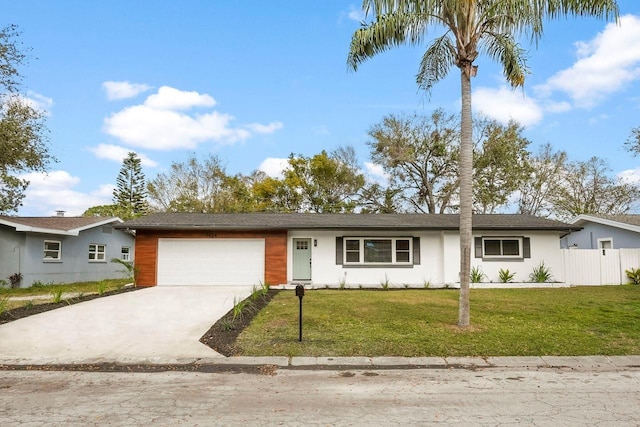 ranch-style home with a garage and a front lawn