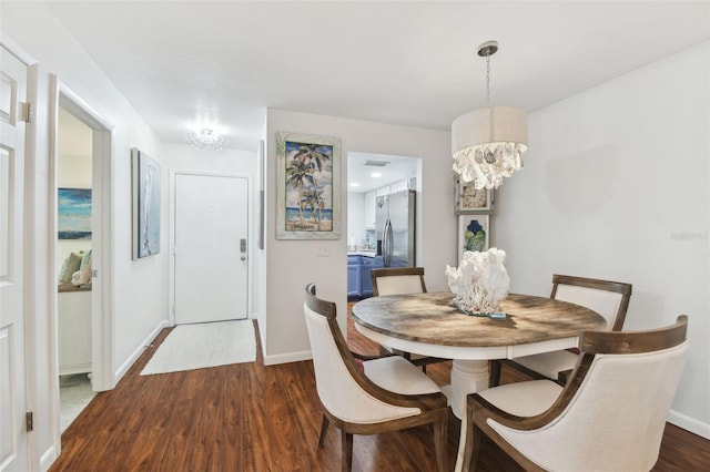 dining space featuring a chandelier and dark hardwood / wood-style flooring