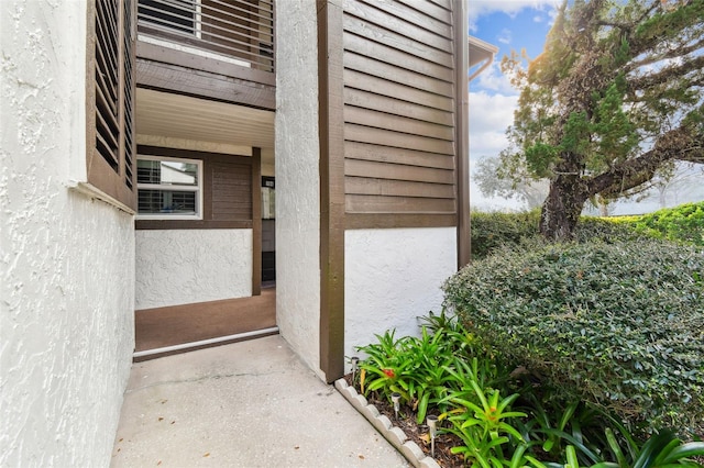 doorway to property featuring stucco siding