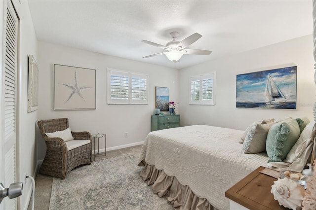 carpeted bedroom featuring baseboards and ceiling fan