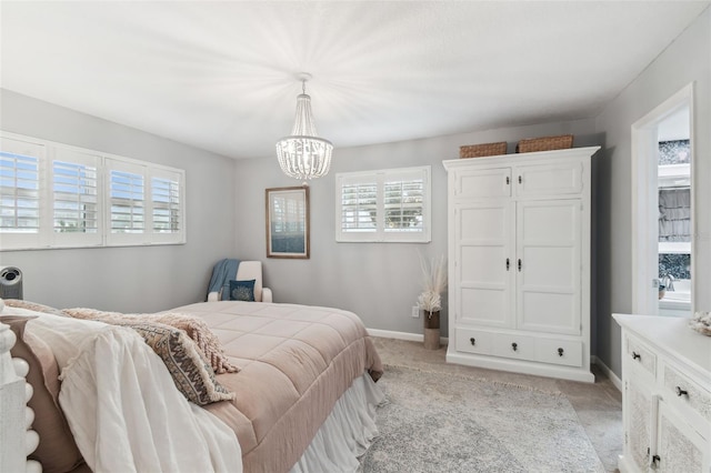 bedroom featuring an inviting chandelier, light colored carpet, baseboards, and multiple windows