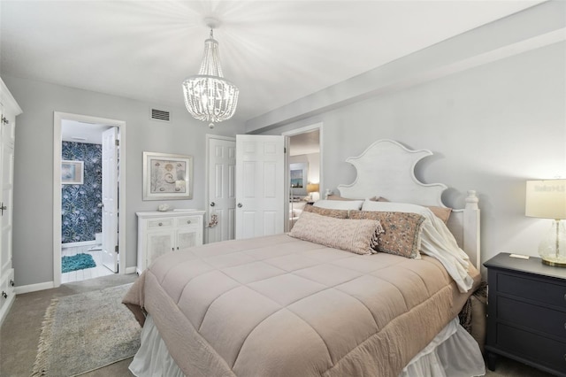bedroom with a notable chandelier, visible vents, baseboards, carpet floors, and ensuite bath