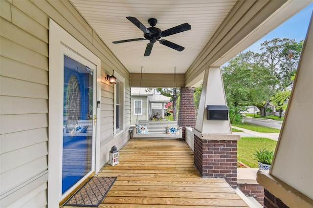 wooden deck featuring ceiling fan and a porch