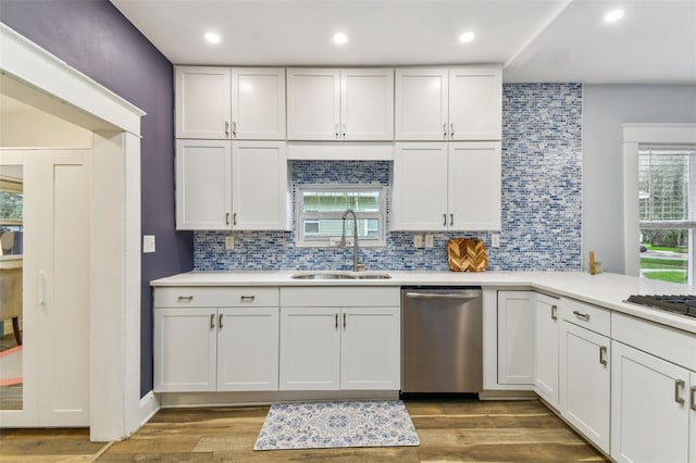 kitchen featuring white cabinetry, appliances with stainless steel finishes, sink, and hardwood / wood-style floors