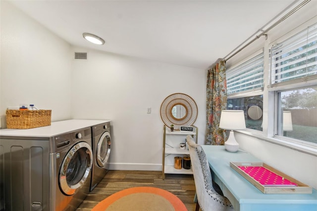 laundry area with dark hardwood / wood-style flooring and washer and dryer