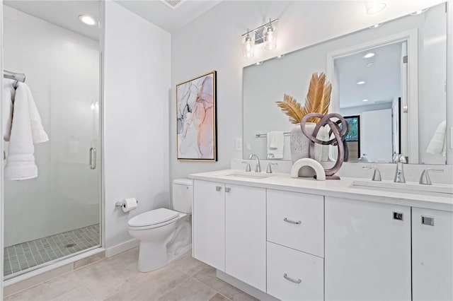 full bathroom with double vanity, a stall shower, tile patterned flooring, and a sink