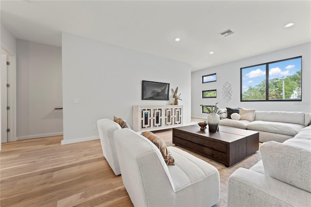 living room featuring baseboards, recessed lighting, visible vents, and light wood-style floors