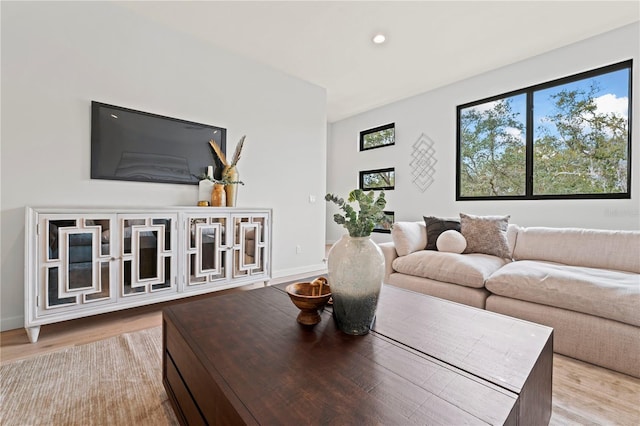 living area featuring recessed lighting, light wood-style flooring, and baseboards