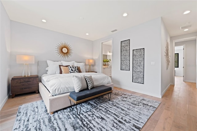 bedroom featuring light wood-style floors, recessed lighting, baseboards, and ensuite bathroom