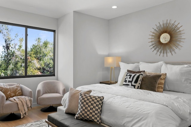 bedroom with multiple windows, wood finished floors, and recessed lighting