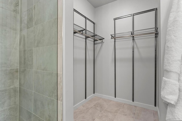 spacious closet featuring light tile patterned floors