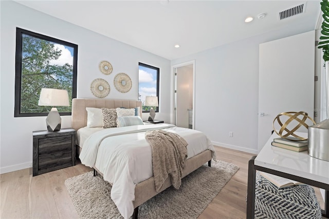 bedroom with recessed lighting, baseboards, visible vents, and light wood finished floors