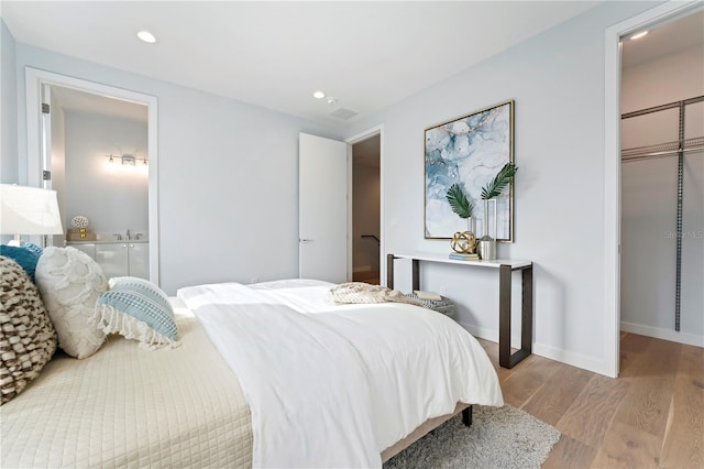 bedroom with light wood-style flooring, baseboards, and recessed lighting