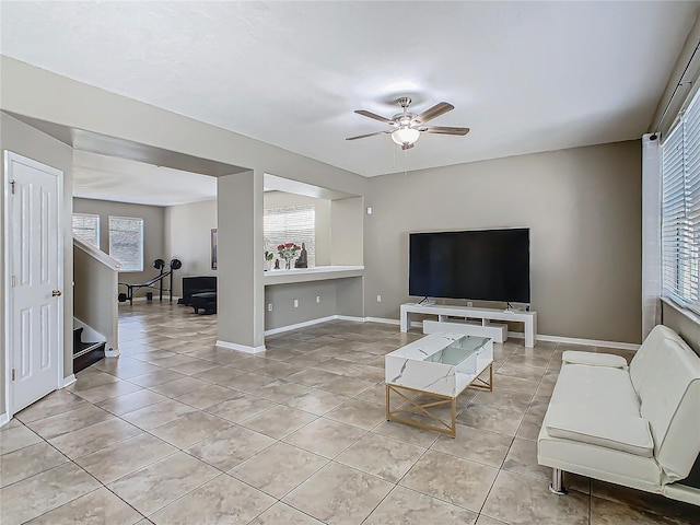 living room with a healthy amount of sunlight, ceiling fan, and light tile patterned floors