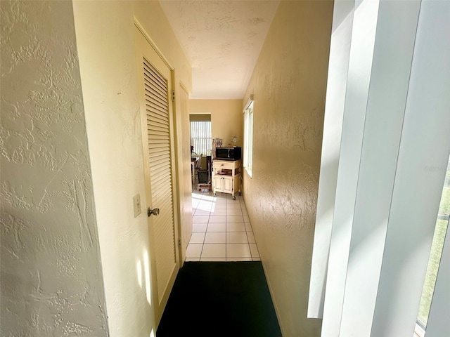 hall with light tile patterned flooring