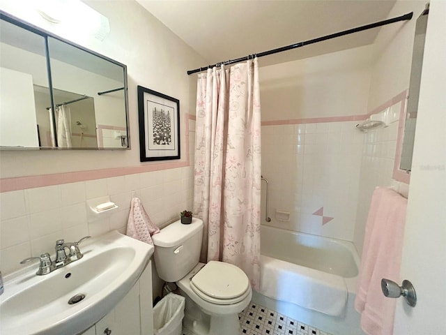 full bathroom featuring tile walls, sink, toilet, and shower / bath combo with shower curtain