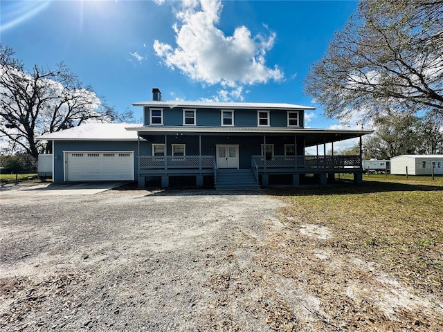 view of front of house with a porch and a garage