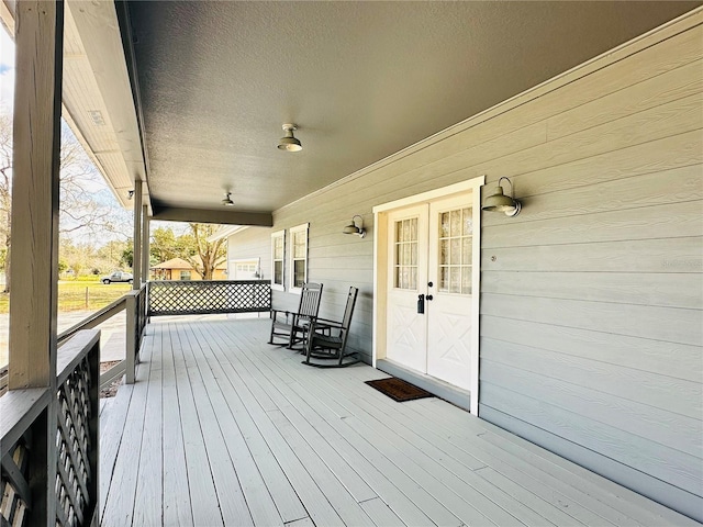 wooden terrace featuring covered porch
