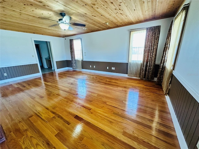 interior space with wood ceiling, ceiling fan, and light hardwood / wood-style floors