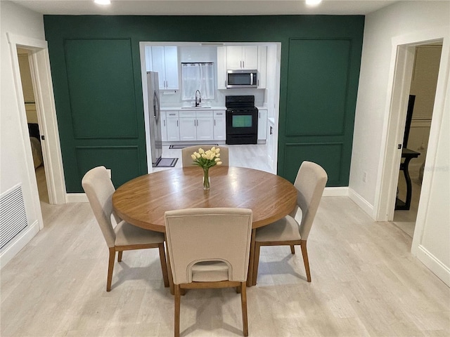 2613 E 23rd Ave, Tampa, FL 33605 - dining area featuring sink and light hardwood / wood-style flooring