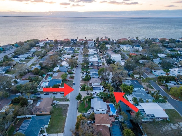 birds eye view of property featuring a water view and a residential view