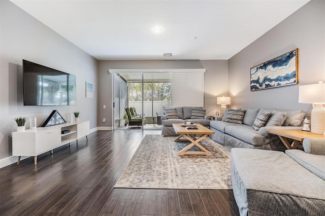 living room with dark wood-style floors, visible vents, and baseboards