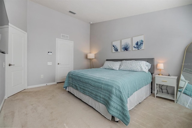 bedroom with lofted ceiling, baseboards, visible vents, and light colored carpet