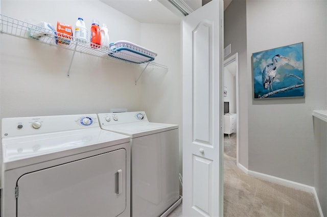 washroom featuring laundry area, light carpet, independent washer and dryer, and baseboards