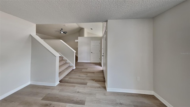 foyer entrance featuring a textured ceiling and light wood-type flooring