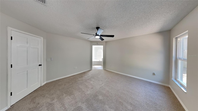 spare room with light carpet, a textured ceiling, and ceiling fan