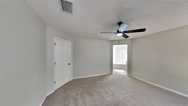 unfurnished room with light carpet, a textured ceiling, and ceiling fan