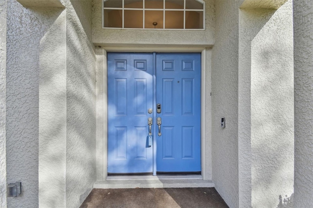 doorway to property with stucco siding