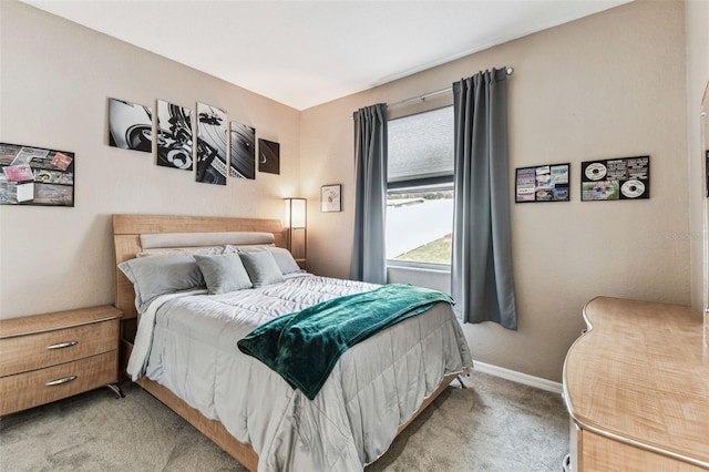 bedroom with light carpet and baseboards