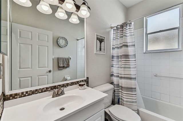 bathroom featuring shower / bathtub combination with curtain, vanity, and toilet