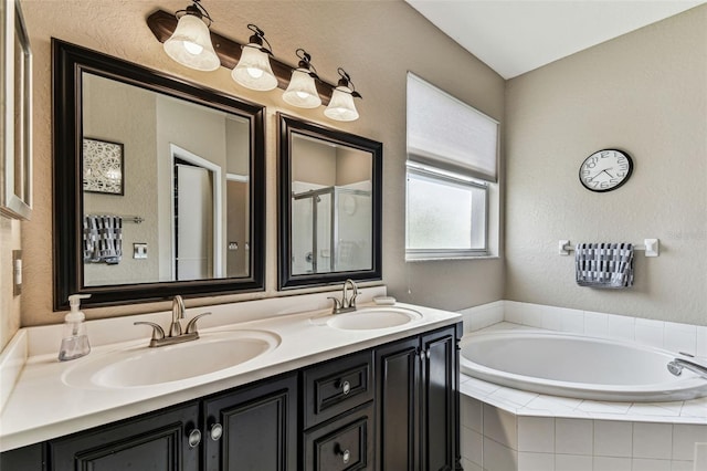 bathroom featuring double vanity, a sink, a shower stall, and a bath