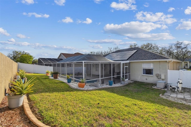 back of house with a patio, a fenced backyard, a shingled roof, a yard, and stucco siding