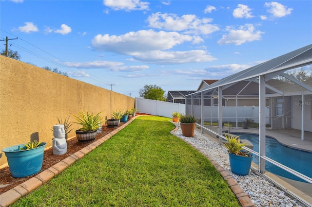 view of yard featuring a fenced in pool, a patio area, a lanai, and a fenced backyard